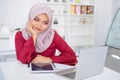 Happy muslim business woman working