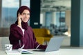 Happy muslim businesswoman in hijab at office workplace. Smiling Arabic woman working on laptop and talking on Royalty Free Stock Photo