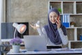 Happy Muslim businesswoman in hijab at work Smiling Arab woman working on laptop Royalty Free Stock Photo