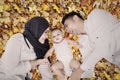 Happy muslim family on autumn leaves Royalty Free Stock Photo