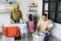 Happy muslim family doing laundry at home Royalty Free Stock Photo