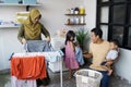 Happy muslim family doing laundry at home Royalty Free Stock Photo