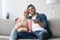 Happy muslim family watching TV together at home Royalty Free Stock Photo