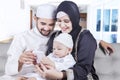 Happy muslim family use cellphone at home