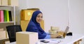 Beautiful muslim female merchandiser doing online marketing at the office