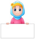 Happy muslim girl wearing blue veil holding blank sign