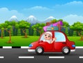Happy Muslim kid in the red car with mountain background