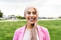 Happy Muslim woman having fun while posing in front of camera in the park Royalty Free Stock Photo