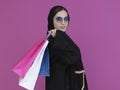 Happy Muslim woman posing with shopping bags