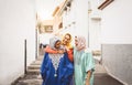 Happy Muslim women walking in the city center - Arabian young girls having fun spending time and laughing together outdoor Royalty Free Stock Photo