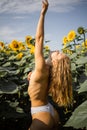 Happy Naked Blonde Woman In A Field Of Sunflowers. Royalty Free Stock Photo