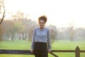 Happy natural young woman standing outdoors