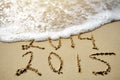 Happy Near Year concept 2015 replace 2014 on sea beach Royalty Free Stock Photo