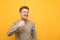 Happy nerd with mustache and glasses shows thumb up and looks into camera with happy face on yellow background. Geek in glasses Royalty Free Stock Photo