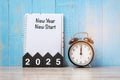 2025 Happy New Yea New start, black retro alarm clock and wooden number.Resolution, Goals, Plan, Action and Mission Concept