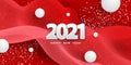 Happy new year 2021. Festive red background with white numbers, confetti, balls and striped drapery fabric. Royalty Free Stock Photo