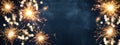 HAPPY NEW YEAR 2022 background greeting card - Firework, sparklers and bokeh lights and sparklers on dark blue night sky Royalty Free Stock Photo