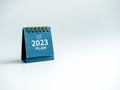 Happy new year 2023 background. 2023 numbers year with text `PLAN`, word, and target icon on blue desk calendar.