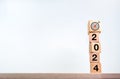 2024 Happy New year background. Target dart icon on wood on top of 2024 year numbers on wooden cube blocks. Royalty Free Stock Photo