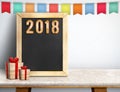 Happy new year 2018 on blackboard with gift and colorful flag ba Royalty Free Stock Photo