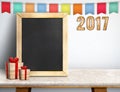 Happy new year on blackboard with gift and colorful flag banner Royalty Free Stock Photo