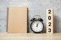 2023 Happy New Year with blank notebook, black retro alarm clock and wooden number. countdown, Resolution, Goals, Plan, Action and Royalty Free Stock Photo
