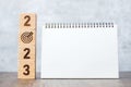 2023 Happy New Year with blank notebook and wooden number. countdown, Resolution, Goals, Plan, Action and Mission Concept Royalty Free Stock Photo