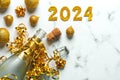 Happy new year 2024. Bottle of of champagne with christmas balls and golden numbers with the number 2024. New Years Eve