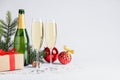 Happy New Year! Bottle of sparkling wine, glasses and festive decor on white background, space for text Royalty Free Stock Photo