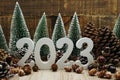 Happy New year calendar 2023 concept decoration with Christmas tree and pine cones on wooden background Royalty Free Stock Photo