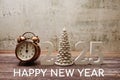 Happy New Year 2025 Calligraphy alphabet letter and Vintage alarm clock with space copy on wooden background Royalty Free Stock Photo