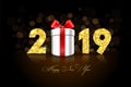 Happy New year card. 3D gift box, ribbon bow, gold number 2019 isolated black background. Golden texture Christmas Royalty Free Stock Photo