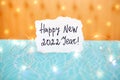 Happy new year 2022 - card with numbers and colorful decorations on blue and yellow background with glitter golden lights Royalty Free Stock Photo
