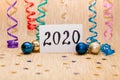 Happy new year 2020 - card with numbers and colorful decorations on glitter gold