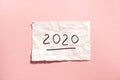 2020 Happy new year card with numbers, paper on pink background