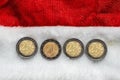 Happy new year celebration background. Coins make 2022 on a red Santa Claus hat