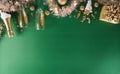 Happy New year celebration background concept. Champagne with glass, golden ribbon, stars and christmas ball on green background