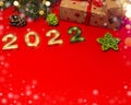 Happy new year celebration concept, gifts and golden numbers 2022 on red background with copy space Royalty Free Stock Photo