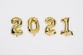 Happy New year 2021 celebration. Gold foil balloons numeral 2020 on white background Royalty Free Stock Photo