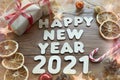 Happy new year 2021. Christmas composition. New year`s layout on a dark wooden background. Cones, toys, gift, garland