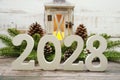 2028 Happy New Year with Christmas lantern decorative on wooden background