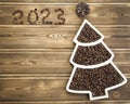 Happy New Year 2023. Christmas pine nuts in saucers in the form of a Christmas tree. Christmas wooden Royalty Free Stock Photo