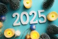 2025 Happy New Year with Christmas tree and Led candles decoration on blue background