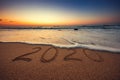 Happy New Year 2020 concept, lettering on the beach. Sea sunrise Royalty Free Stock Photo