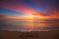 Happy New Year 2020 concept, lettering on the beach. Sea sunrise Royalty Free Stock Photo