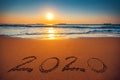 Happy New Year 2020 concept, lettering on the beach. Sea sunrise Royalty Free Stock Photo