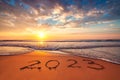 Concept of freedom, motivation, relaxation, happiness and lifestyle. New Year 2023 text lettering on the beach sand at sunrise. Tr