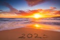 Happy New Year 2023 travel and lifestyle concept, text lettering on the beach shore. Ocean sunrise. Sea sunset.