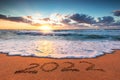 Happy New Year 2022 concept on the sea beach sand ; ocean sunrise Royalty Free Stock Photo