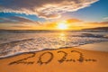 Happy New Year 2022 concept, lettering on the beach. Written text on the sea beach at sunrise Royalty Free Stock Photo